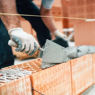 Image of person laying bricks