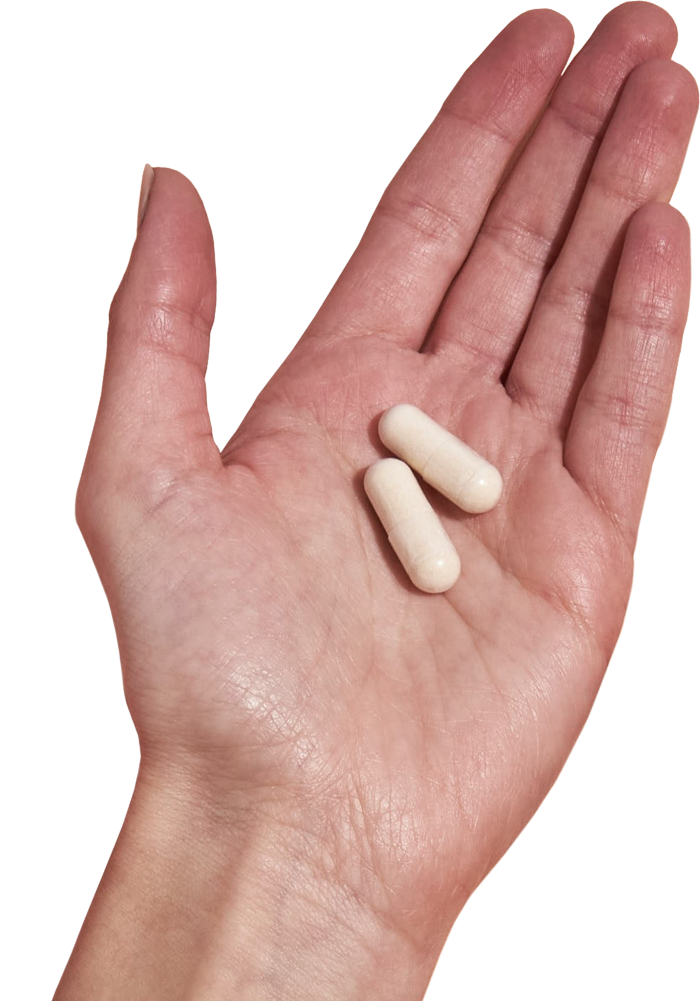 image of hand holding 2 Performance Lab® CA Magnesium capsules