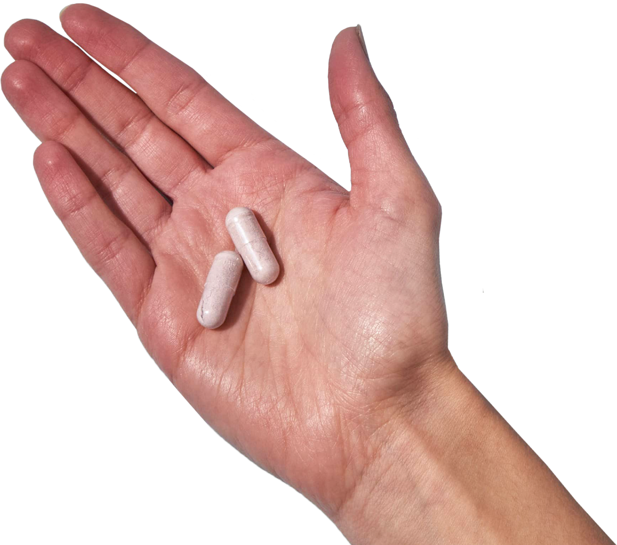 image of a hand holding 2 Performance Lab® Sleep capsules