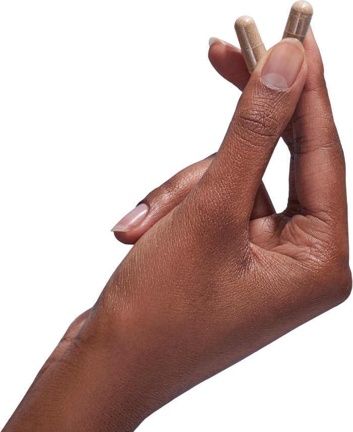 image of hand holding 2 Performance Lab® CA Vitamin C capsules